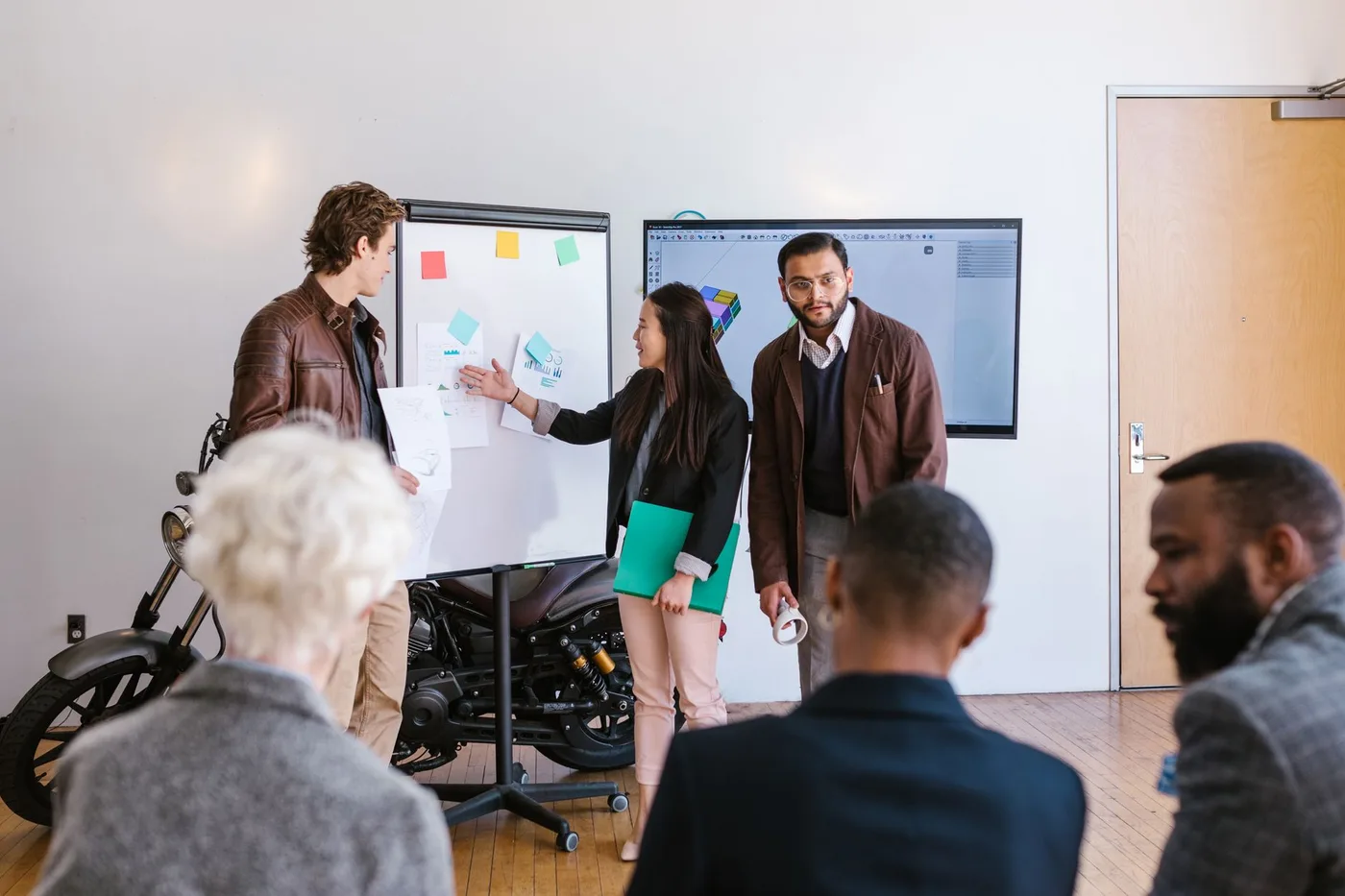 A digital marketing agency team meeting reviewing campaign performance and a strategy dashboard
